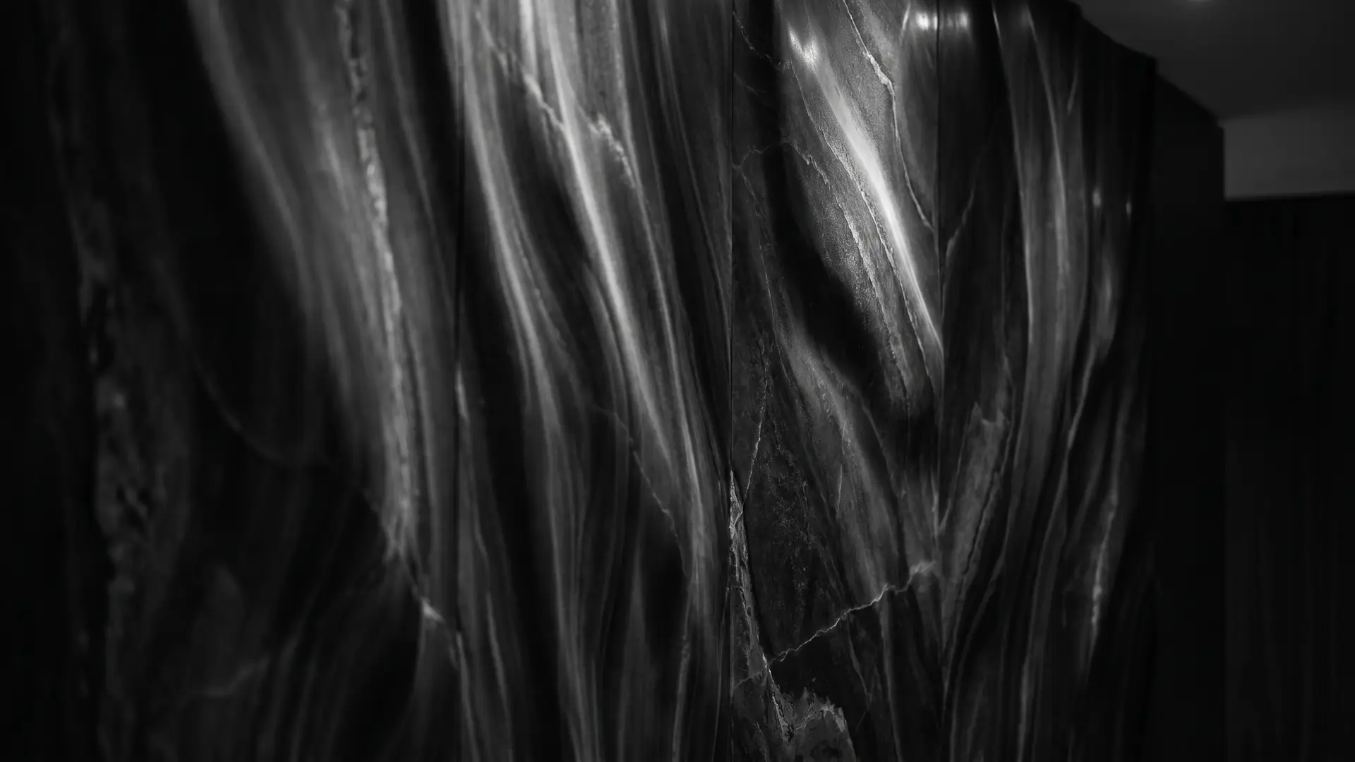 Slow cinematic footage of moody shifting silk and dark stone