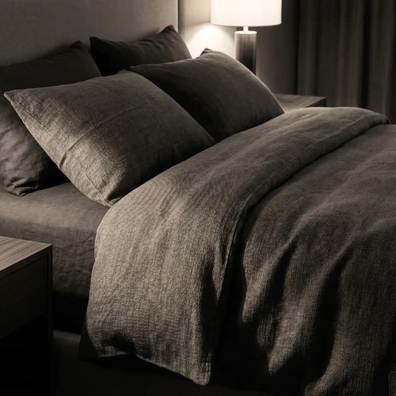Dimly lit luxury suite with textured linens and warm directional light